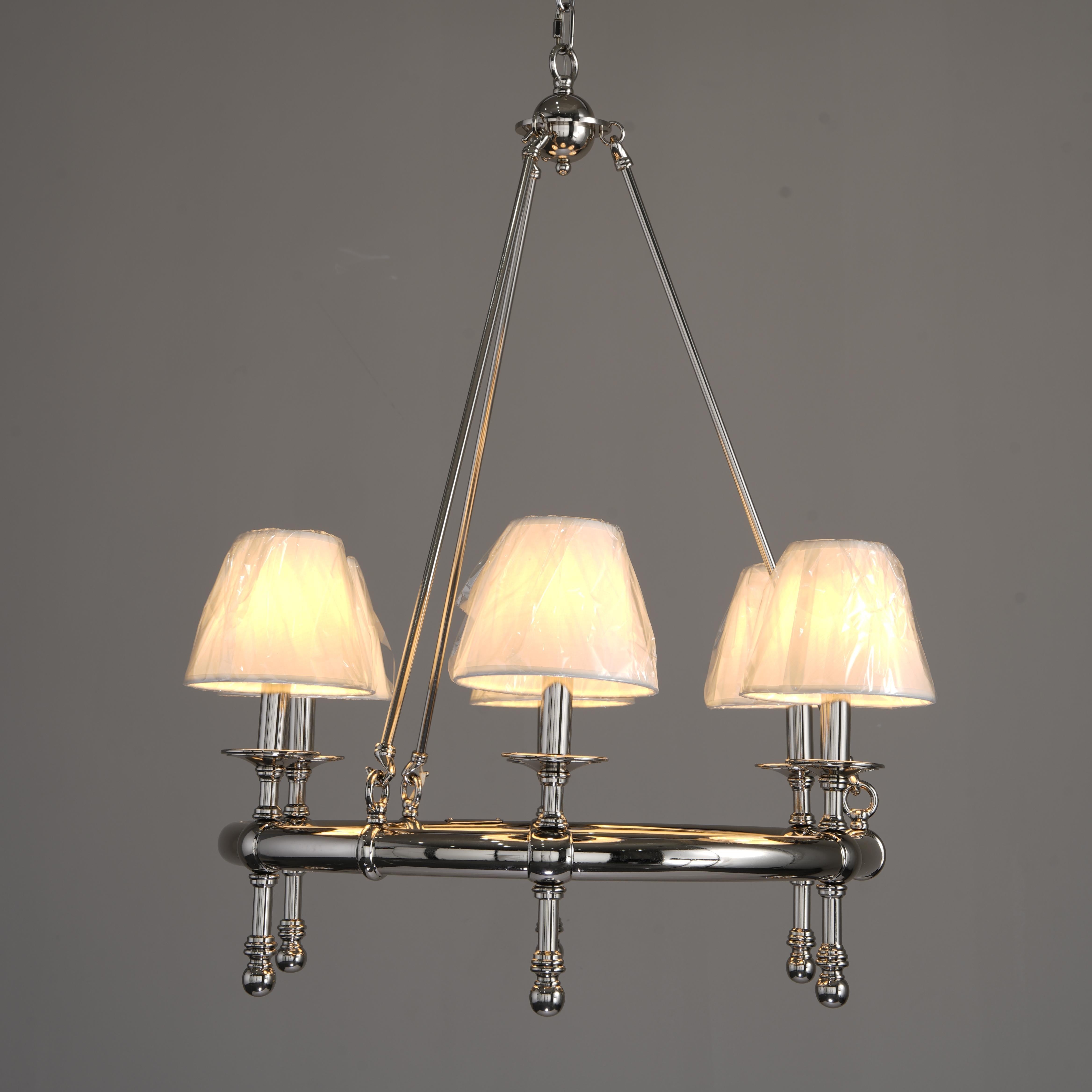 Chandelier with three lampshades on a gray background