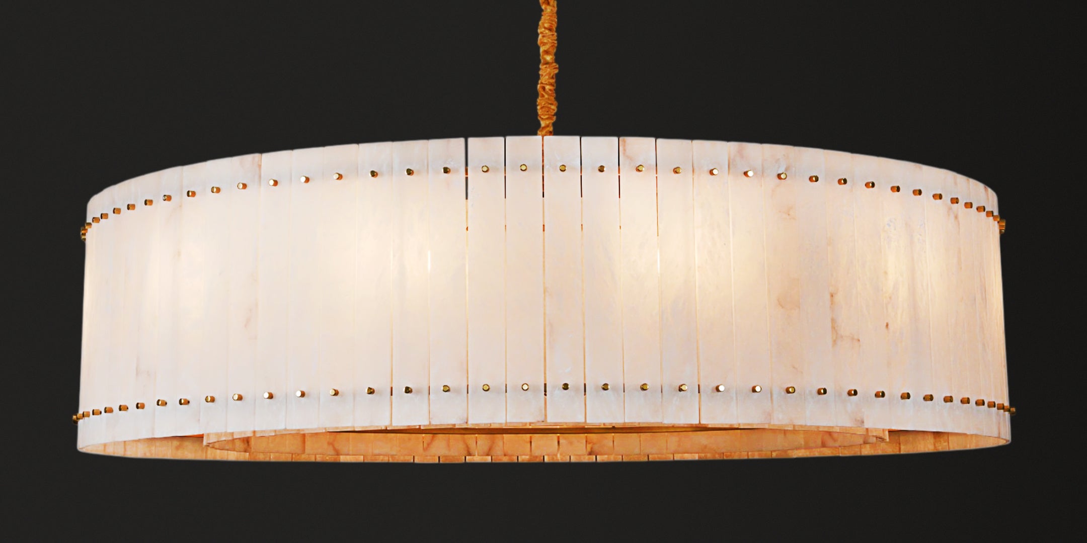 Large pendant light with a white lampshade on a black background