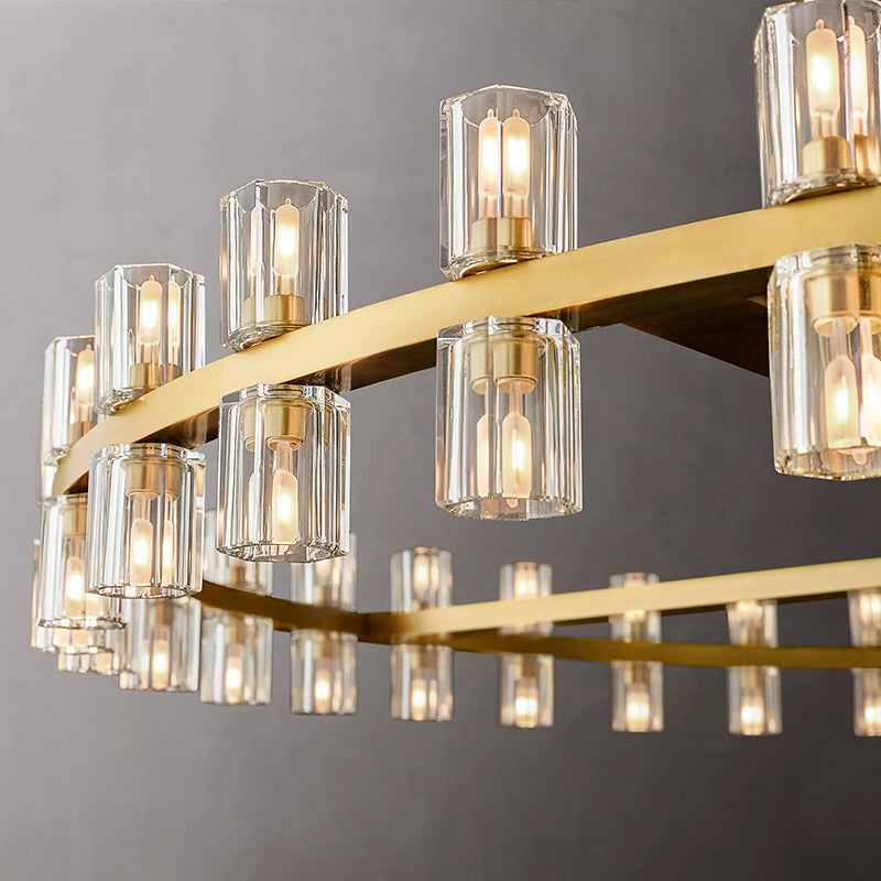 The rhythmic design of this chandelier collection is inspired by the shape and scale of industrial gears, where spokes are interlaced with negative space to interlock with other gears. Here, the spokes are hexagonal in form, juxtaposed with a circular interior, crafted from crystal glass, running along a simple, sturdy metal frame. The light shines through the glass as if it were a candle.